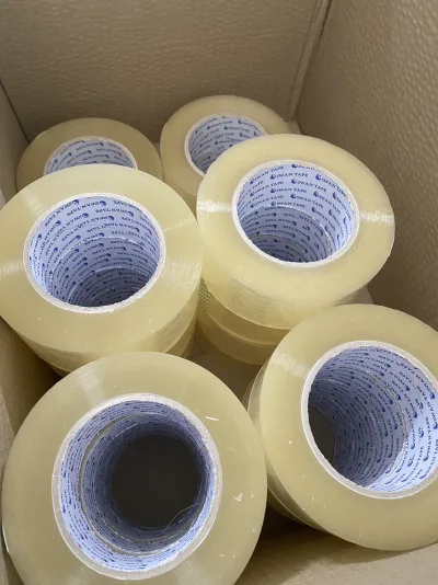 ม้วนเทปใสเรียงเต็มกล่องกระดาษ มองจากด้านบนเห็นแกนม้วนชัด — SWAN TAPE โรงงานผลิตเทปกาว
