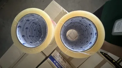 ม้วนเทปใส SWAN TAPE สองม้วนถ่ายจากด้านหน้าตัด เห็นแกนกระดาษพิมพ์โลโก้ชัด — SWAN TAPE โรงงานผลิตเทปกาว