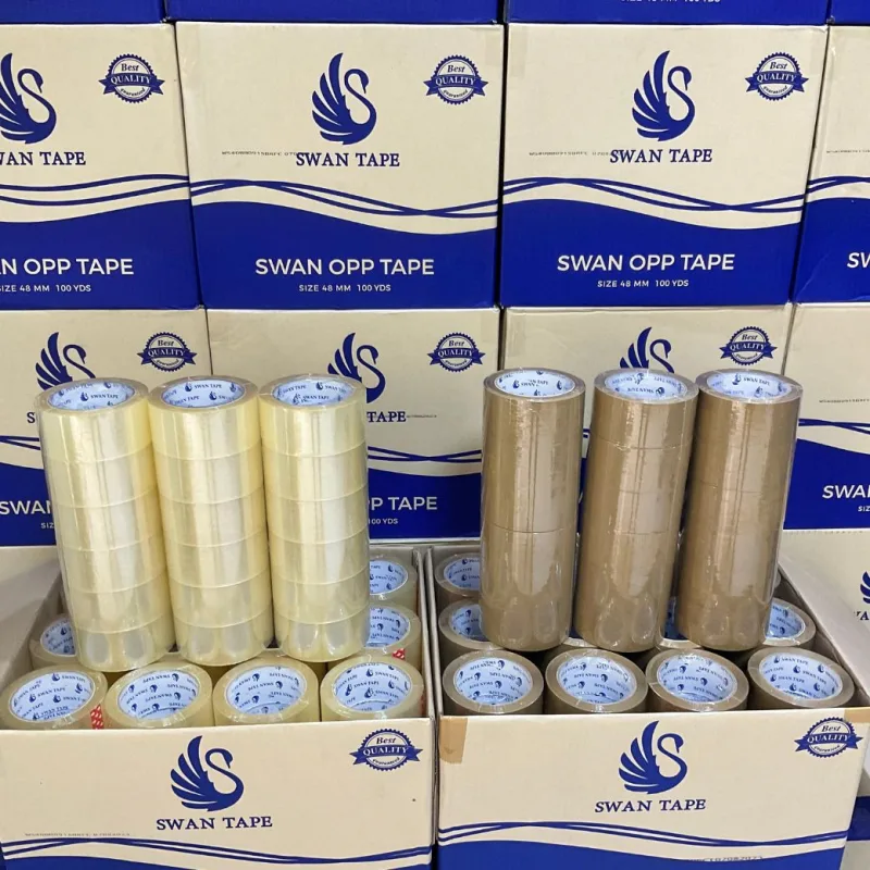 เทปกาว OPP ใสและสีน้ำตาล SWAN TAPE จัดเรียงพร้อมกล่องสินค้า